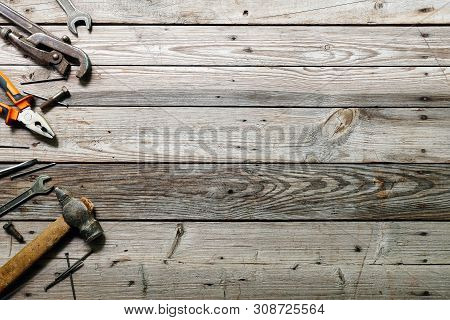 Flat Lay Composition With Vintage Carpentry Tools On Rough Wooden Background. Top View Workbench Wit