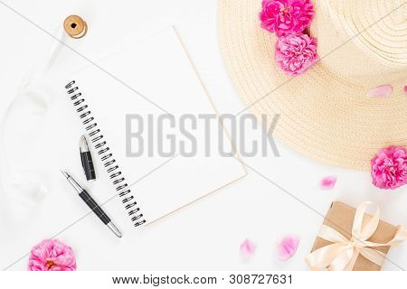 Flat Lay Home Office Desk. Women Workspace With Blank Paper Notepad, Straw Hat, Pink Rose Flowers, F