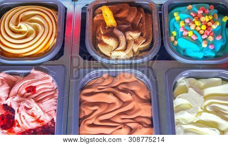 Delicious Ice Cream Of Different Flavors And Colors On A Confectionery Shop