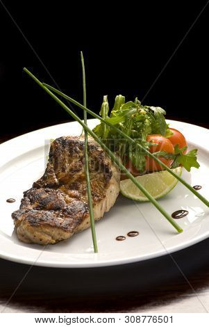 Well-done Steak With Suace And Vagetables. Reastaurant Dishes On The Wooden Table. Food Photo For Re
