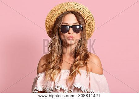 Beautiful Woman Making Kissing Gesture, Keeps Lips Rounded, Attractive Female Wearing Summer Outfit 