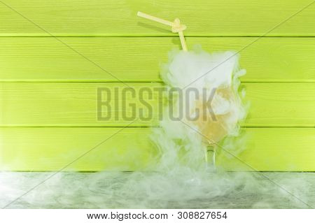 Cocktail With Liquid Nitrogen. Summer Cooling Cocktail In A Glass Glass With A Straw. From Liquid Ni