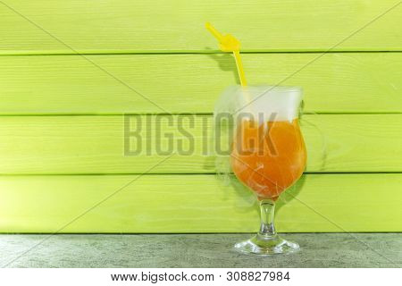 Cocktail With Liquid Nitrogen. Summer Cooling Orange Cocktail In A Glass Beaker With A Straw. From L