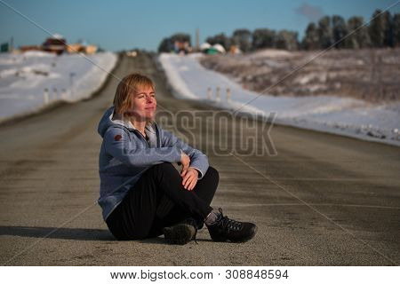 Mountain Altai. Russia. 04/22/2019. The Girl Sitting In The Middle Of The Chui Tract On The Seminsky