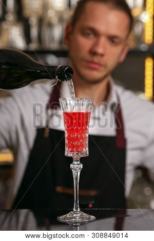 Barmen Is Making Kir Royal Cocktail With Orange Slice And Ice Cubes