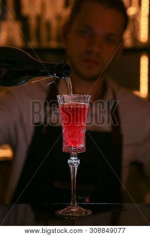 Barmen Is Making Kir Royal Cocktail With Orange Slice And Ice Cubes