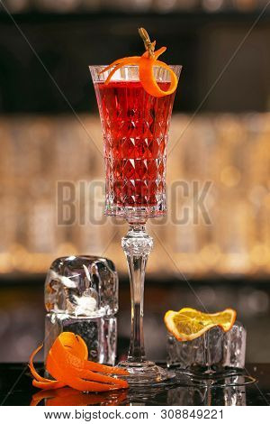 Barmen Is Making Kir Royal Cocktail With Orange Slice And Ice Cubes