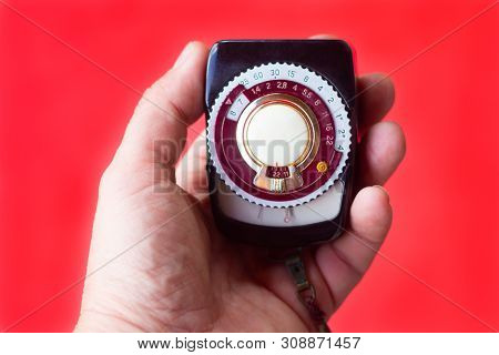 Old Vintage Soviet Exposure Meter With Leather Case On Red Background