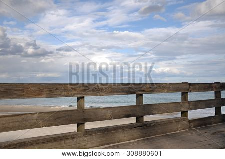 Wooden Fence, Fencing Off The Observation Deck On The Beach From The Sand And The Sea. Blue Spring S