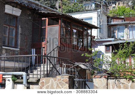 A Variety Of Small Houses, Built On The Slope Of The Resort Town. Windows, Balconies, Grills, Stairs