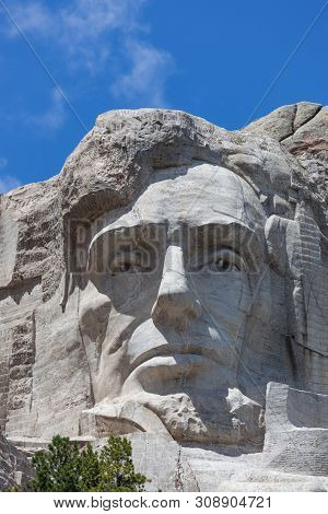 Looking Up At A Carved Likeness Of Abraham Lincoln, One Of Four United States Presidents Carved Into
