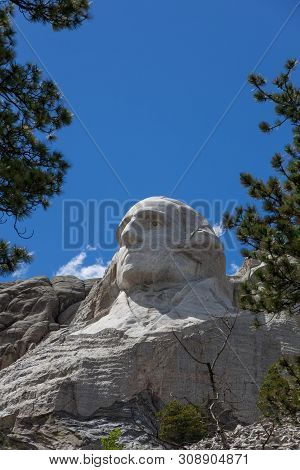 Looking Up At A Carved Likeness Of George Washington, One Of Four United States Presidents Carved In