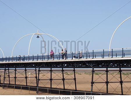 Southport, Merseyside, United Kingdom - 28 June 2019: People On The Historic Pier In Southport Merse