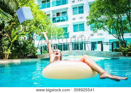 Woman Swims In The Swimming Pool In The Pool And Throws The Laptop Into The Water. The Girl Is Resti