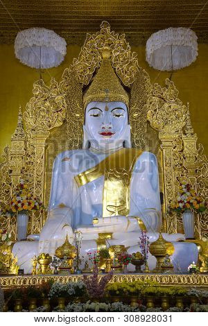 Mandalay, Myanmar - December 19, 2016: A Large Sculpture Of A Sitting Buddha In A Buddhist Temple Ky