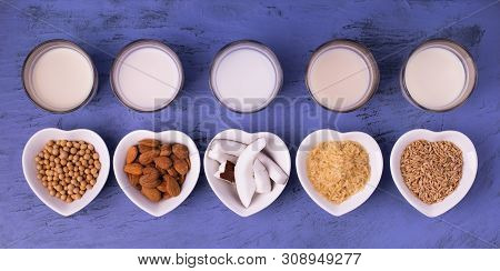 Types Of Vegetable Milk, Organic, In Glasses On The Blue Stone Table. View From Above