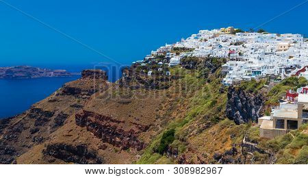 Skaros Rock, White Houses And The Sea In Background. Santorini, Greece.