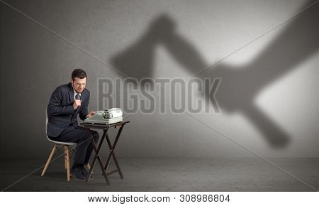 Shadow threatening hard worker man who is afraid