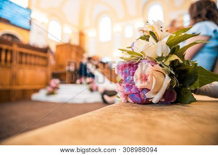 A Bouquet Of Flowers With Wedding Hall And Quests At The Background