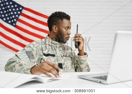 Worker Of American Army Writing Documents, Using Laptop And Destination Radio Remote, Talking With C
