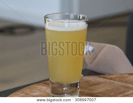 Close Up Of Glass Filled With Radler, Mixture Of Beer And Sparkling Lemonade, On Wooden Background