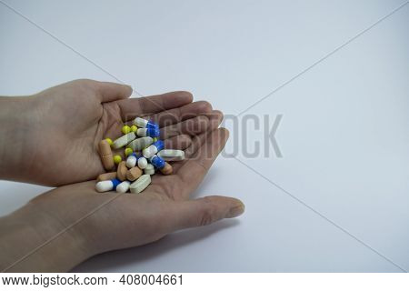 A Handful Of Colored Pills In The Palm