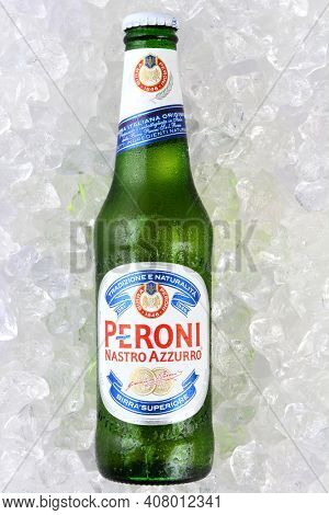 IRVINE, CA - JANUARY 11, 2015: A single bottle of Peroni Beer on a bed of ice. Founded n the town of Vigevano, Italy in 1846. The company was moved to Rome by Giovanni Peroni in 1864.