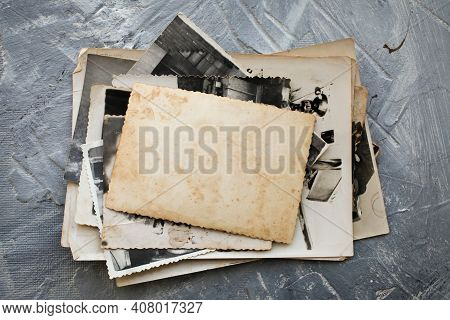 Stack Old Photos  On Grey Background.  Postcard Rumpled And Dirty Vintage. Retro Card