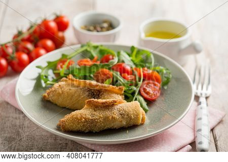 rolled sword fish with capers arugula and tomatoes salad