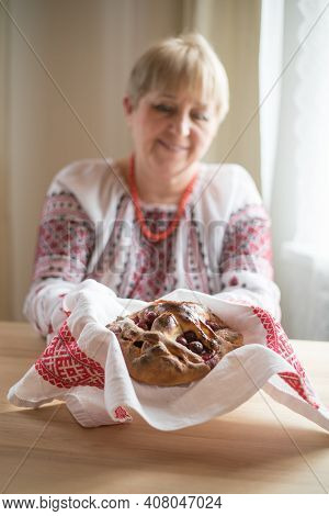 Homemade Cherry Pie In Hands Of Woman Wearing Traditional Ukrainian Costume