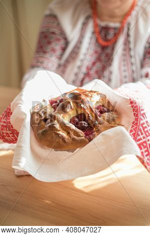 Homemade Cherry Pie In Hands Of Woman Wearing Traditional Ukrainian Costume