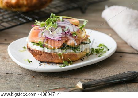 Smoked Salmon Bagels Sandwich With Soft Cheese And Micro Greens On A Cutting Board.bagel. Heap Of Fr