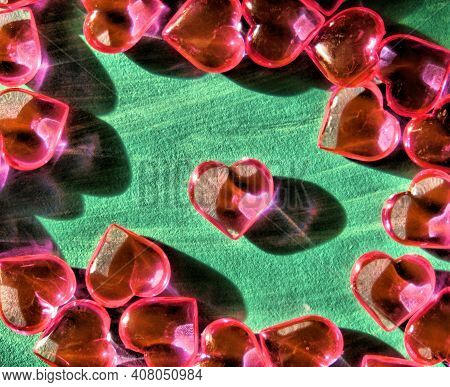 Crystal Hearts On Green Painted Surface, Brurred,  Hard Shadow, Copy Space.  Holiday Banner, Web Pos