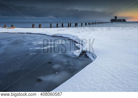 Winter Landscape At The Sea. Frozen Wooden Breakwaters Line To The World War Ii Torpedo Platform At 