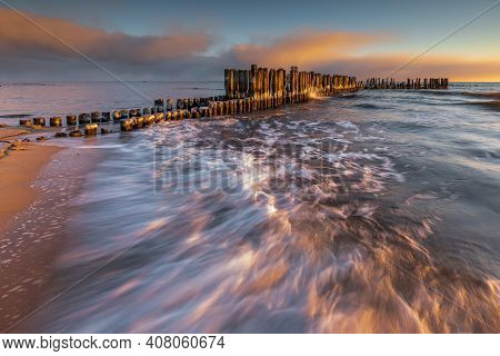 Winter Landscape At The Sea. Frozen Wooden Breakwaters Line To The World War Ii Torpedo Platform At 