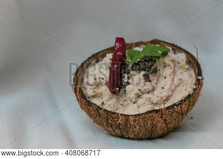 The Coconut Chutney Served In A Coconut Shell With White Background