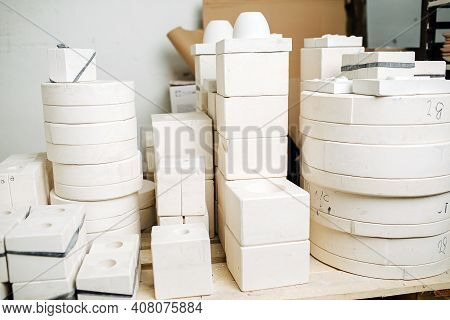 Stack Of Molds For Casting Tableware Of Different Size And Shape.