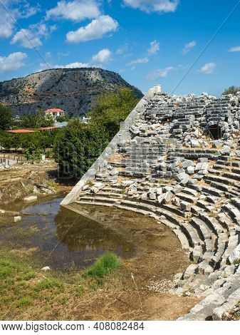 Ruins of Theatre in Letoon Ancient City in village Kumluova, Turkey. Sunny day, Greek culture ancient amphitheater architecture vertical photo