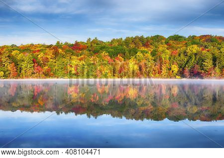 Autumn At Burr Pond State Park In Torrington, Connecticut On A Sunny Blue Sky Morning In New England