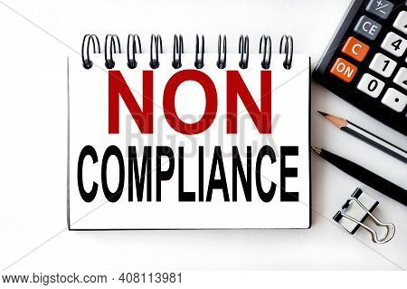 Non Compliance . Text On White Notepad Paper On White Background.