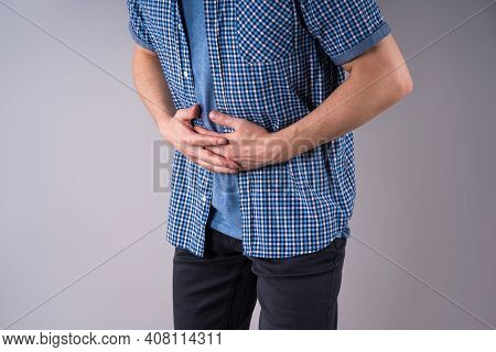Man With Abdominal Pain, Stomach Ache On Gray Background