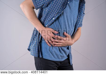 Man With Abdominal Pain, Stomach Ache On Gray Background