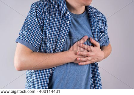 Heart Attack, Diseases Of The Cardiovascular System, Man With Chest Pain On Gray Background