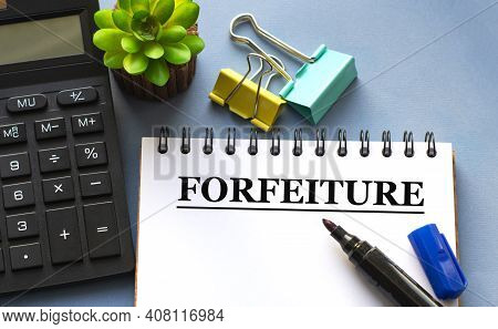 Forfeiture Word Is Written In A Notebook With A Marker, Calculator, Clamps And Cactus. Business Conc