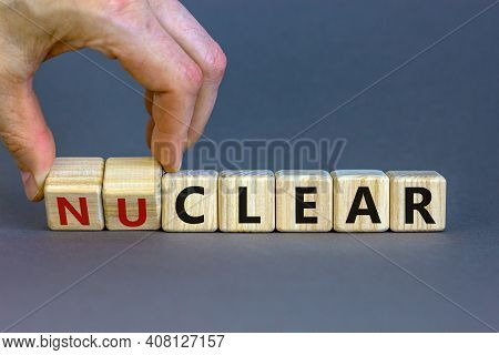 Nuclear Or Clear Symbol. Businessman Turns A Cube And Changes The Word 'nuclear' To 'clear'. Beautif