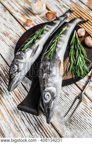 Raw Whole Icefish With Herbs. White Wooden Background. Top View