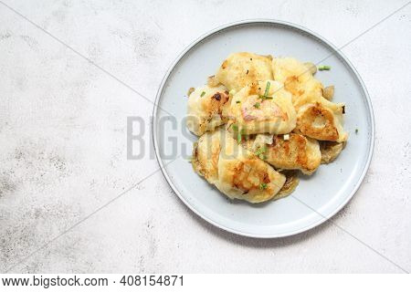 Fried Dumplings, Crispy Dumplings With Fried Onion, Round Plate Full Of Hot Dumplings Sprinkled With