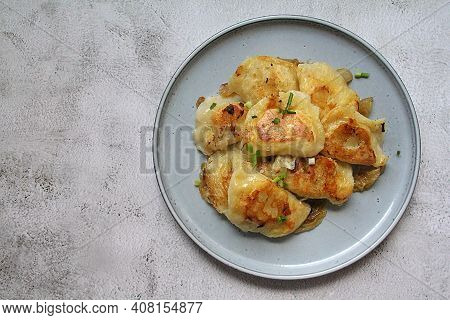 Fried Dumplings, Crispy Dumplings With Fried Onion, Round Plate Full Of Hot Dumplings Sprinkled With