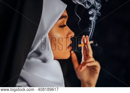 Nun Smoking. Portrait Of A Smoking Young Nun,
