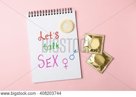Notebook With Let's Talk Sex And Condoms On Pink Background